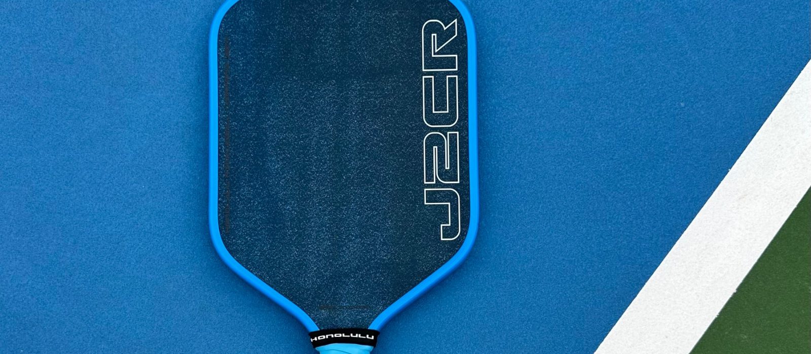 Close-up of a Honolulu pickleball paddle on an indoor court